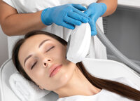 Client receiving LED light therapy for skin treatment at Gloss RVA