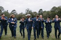 Groom and Groomsman posing for picture at The Rosewood Venue in East Texas