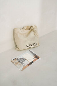 Karina wellness brand Canva template for holistic coaches featuring neutral-toned tote bag and printed brand board showcasing earthy color palette and minimalist design.