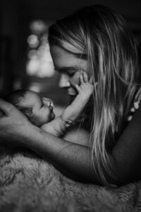 Intimate newborn portrait session in St. Paul, focusing on the close bond between parents and their newborn in a tender, emotional setting.