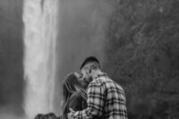 Experience the harmony of nature and romance through this beautiful depiction of a couple at a PNW waterfall, where the scenery amplifies their bond.