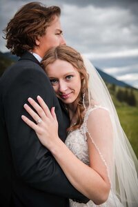 A happy couple embrace one another on their wedding day in Glacier National Park in western Montana.