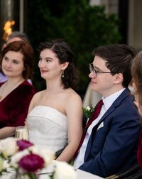 A couple shares a moment at their wedding table at Cedar Knoll, captured by Nathan Sottung Photography