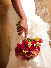 Bride holding a stunning bouquet of red roses, showcasing timeless elegance and romance, designed by In Full Bloom Event Planning & Design