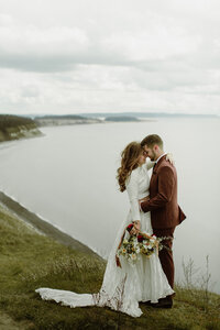 Bride & groom posing with foreheads touching at Ebey's Landing on Whidbey Island!
