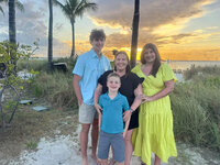 Family at beach sunset from testimonial praising attentive detail-oriented travel planning. Tailored Oasis Travel Co.
