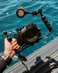 Scuba diving underwater camera in front of the ocean