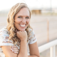 women standing outside on a farm smiling 