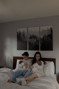 Tender black-and-white photo of new parents holding their newborns, capturing the love, warmth, and beginnings of a family