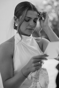 Bride wiping away tears during her wedding ceremony