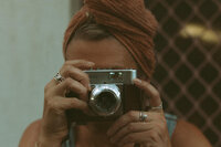 A portrait fo Nicci, Sunshine Coast wedding, events and branding photographer, taking a photo on a vintage film camera.