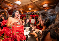 Photo of a guest receiving a make up bag with custom calligraphy