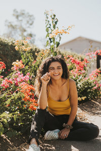 woman sitting on ground smiling