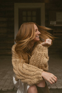 Rae Terrillon, Vancouver Island wedding and elopement photographer, smiling outdoors with natural light.