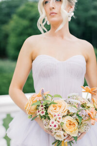 colorful summertime flower arrangement with rose and protea