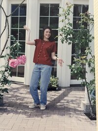 Darcy standing in the middle of a rose garden on a vineyard in Napa Valley.