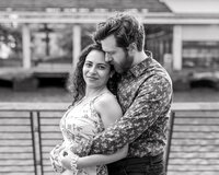 Elegant black-and-white engagement photo featuring a couple looking radiant and deeply in love.