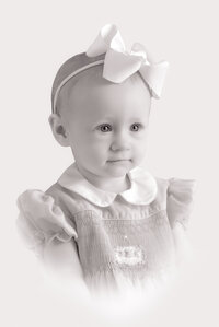 A black and white portrait of a baby girl
