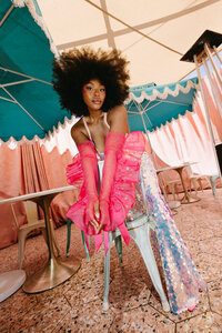 A Vegas Bride with an afro and sparkly jumpsuit