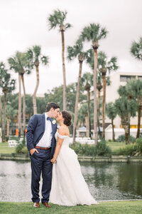 bride and groom posing by the palms in the sonesta hotel hilton head
