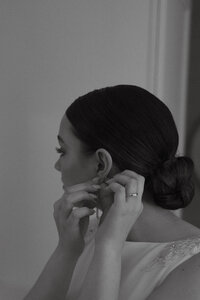 A Tennessee bride putting her jewelry on the morning of her wedding captured in a documentary style.