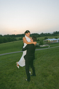 Film photo of groom spinning bride around at Nashville countryside wedding