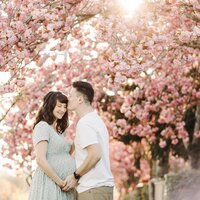 Utah Wedding Photographer captures man and woman standing in blossom trees