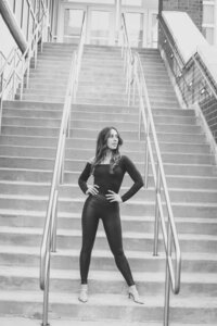 black and white image woman posing on stairs