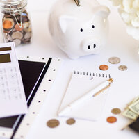 Desk with piggy bank and notepad