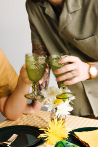 A close up of two hands doing a cheers