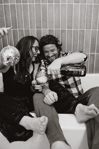Couple partying in a bathtub with champagne and a disco ball in Breckenridge, Colorado.