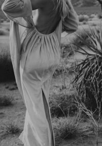 The back of a woman wearing an open back dress, representing the non-traditional esthetic of the Crush Collective wedding expo.