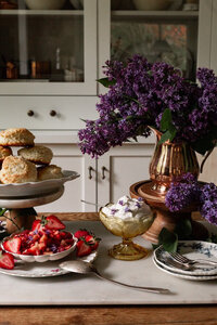 Coppermill Kitchen small pitcher with purple flowers and table decorated with food