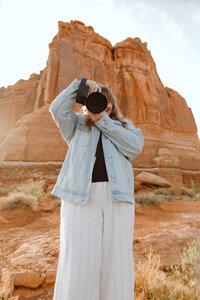 Photogrpaher taking a picture of the rocks at Arches National Park 