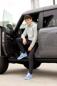 Modern senior portrait of a high school student in Detroit, taken in an urban downtown setting with professional styling.”