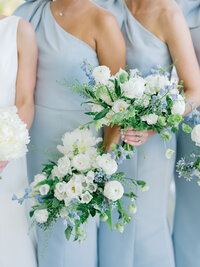 Bridesmaids hold bouquets