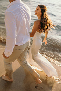 Maui elopement Photographer captures sunset beach wedding when groom kisses bride on forehead