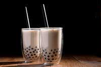 two milk teas filled with boba