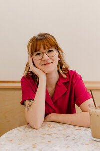 woman sitting on the ground leaning on one arm