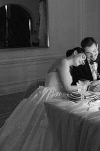 The bride and groom seated at the head table during the wedding reception. Montreal wedding photographer.