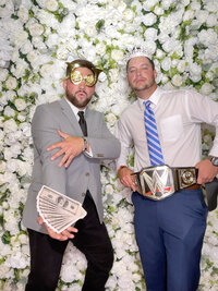 white flower wall 2 guys fun poses