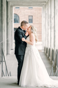 a bride and groom kiss in downtown Omaha