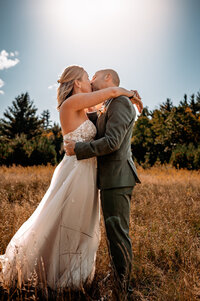 A couple dancing in a field in front of whiteface mountain in upstate NY