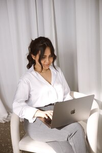 Amare co founder seating and working work laptop