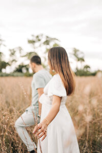 Couple walking on a field captured by Best Palm beach engagement photographer