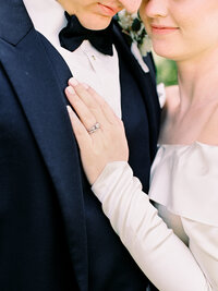 Bride's left hand on groom's lapel after wedding at Cathedral Basilica of the Assumption wedding in Covington, KY