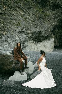 In a dramatic romantic scene, a couple poses in front of iceland beaches during an elopement
