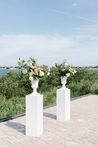 Bridesmaids in soft pastel gowns holding vibrant spring bouquets, styled by Jacksonville wedding planner The Eventful Gals.