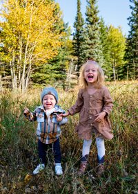 two young kids in grass