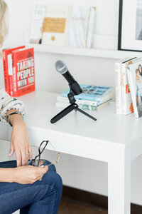 podcast host sitting at her desk